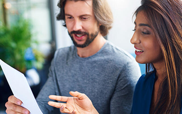 man and woman looking at survey